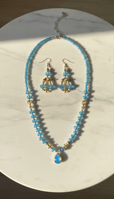 Necklace and earrings set on a marble table 