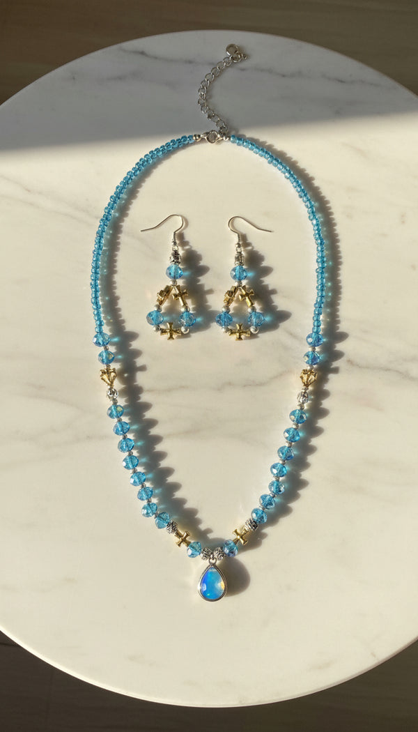 Necklace and earrings set on a marble table 
